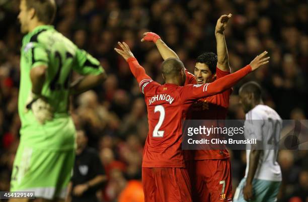 Luis Suarez of Liverpool celebrates scoring his team's third goal with team-mate Glen Johnson during the Barclays Premier League match between...