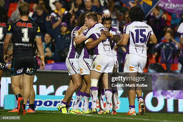 William Chambers of the Storm celebrates with his team mates after scoring a try during the round 24 NRL match between the Penrith Panthers and the...