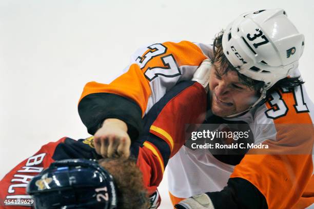 Jay Rosehill of the Philadelphia Flyers and Krys Barch of the Florida Panthers fight during during a NHL game at the BB&T Center on November 25, 2013...