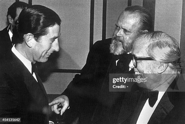 Picture taken on May 10, 1983 in London shows Prince Charles, patron of the British film institute sharing a laugh with film directors, USA's Orson...