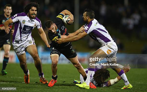 Lewis Brown of the Panthers is tackled during the round 24 NRL match between the Penrith Panthers and the Melbourne Storm at Sportingbet Stadium on...