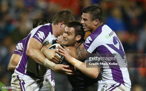 Tim Grant of the Panthers is tackled during the round 24 NRL match between the Penrith Panthers and the Melbourne Storm at Sportingbet Stadium on...