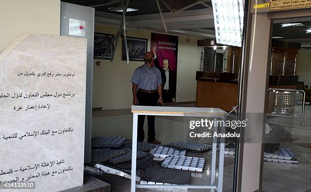 Palestinian man inspects the damage at the travelers' lounge of the Rafah crossing on the Palestinian side following Israeli airstrikes on August 25,...