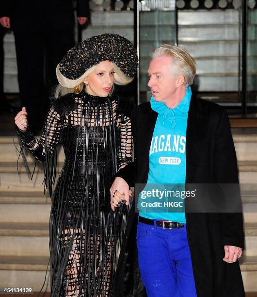 Lady Gaga and hat designer Philip Treacy leave Gaga's London hotel on December 7, 2013 in London, England.