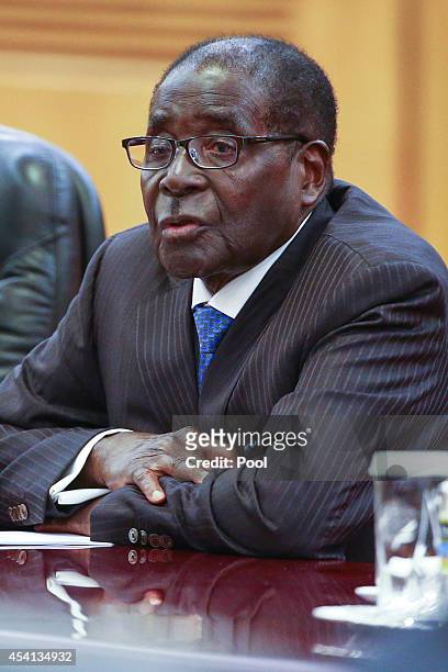 Zimbabwean President Robert Mugabe attends a bilateral meeting with his Chinese counterpart Xi Jinping at the Great Hall of the People on August 25,...