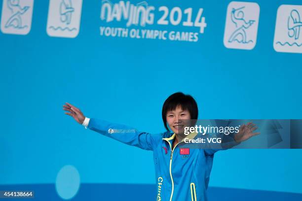 Gold medalist Wu Shengping of China celebrates on the podium after the Women's 3m Springboard Final on day nine of the Nanjing 2014 Summer Youth...