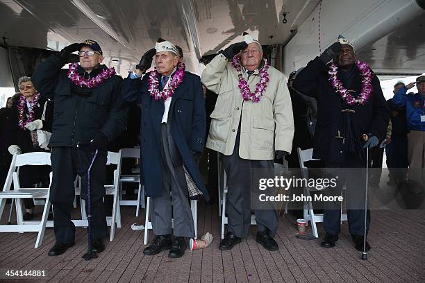 Pearl Harbor survivors salute during the U.S. National anthem at a ceremony marking the 72nd anniversary of the attack on Pearl Harbor, Hawaii on...