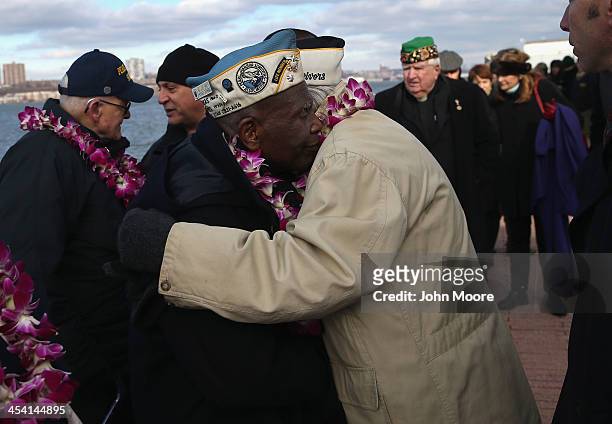Pearl Harbor survivors embrace at a ceremony marking the 72nd anniversary of the attack on Pearl Harbor, Hawaii on December 7, 2013 in New York City....