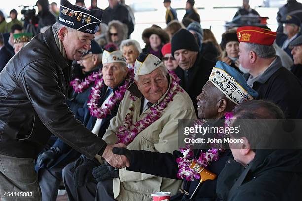 Pearl Harbor survivor Clark Simmons is congratulated after he spoke at a ceremony marking the 72nd anniversary of the attack on Pearl Harbor, Hawaii...