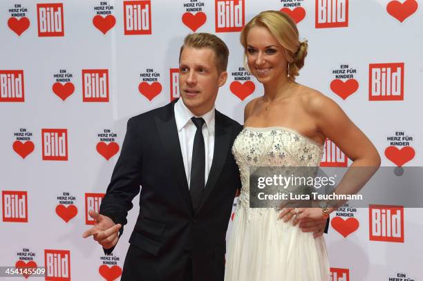 Oliver Pocher and Sabine Lisicki attend the Ein Herz Fuer Kinder Gala 2013 at Flughafen Tempelhof on December 7, 2013 in Berlin, Germany.