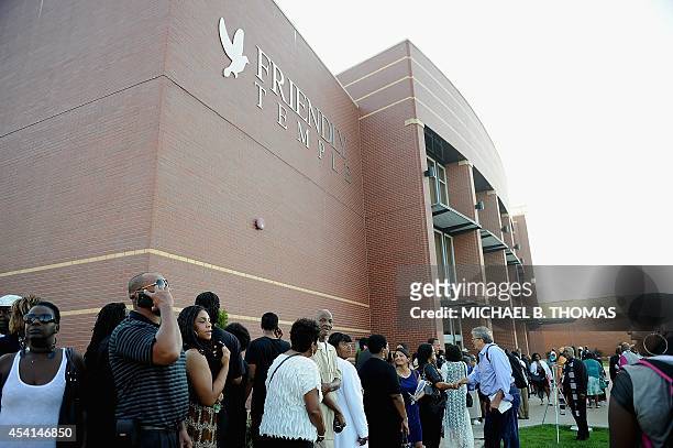 Funeral goers line up to enter the Friendly Temple Missionary Baptist Church for the funeral of slain 18-year old teenager Michael Brown Jr. In St....