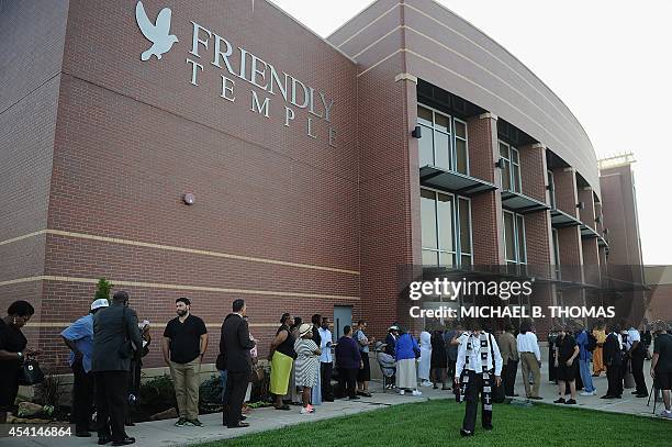 Funeral goers line up to enter the Friendly Temple Missionary Baptist Church for the funeral of slain 18-year old teenager Michael Brown Jr. In St....