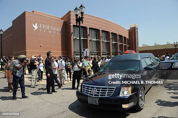 The hearse bearing the casket of slain 18-year-old Michael Brown Jr. Departs for the cemetery following funeral services at Friendly Temple...