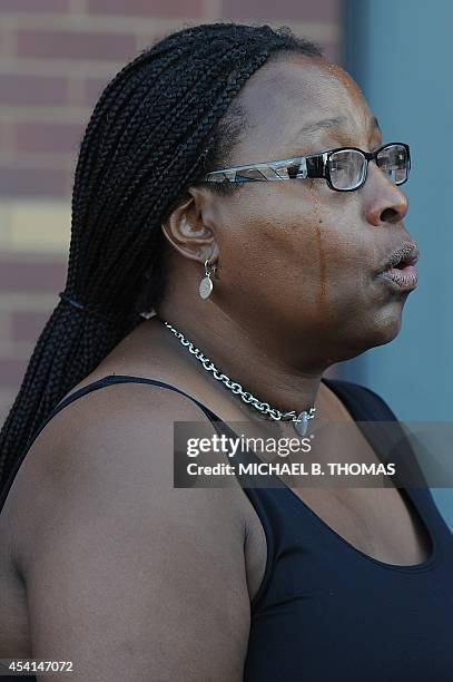 Woman cries as she sings hymns during funeral services for 18-year-old Michael Brown Jr. At the Friendly Temple Missionary Baptist Church in St....