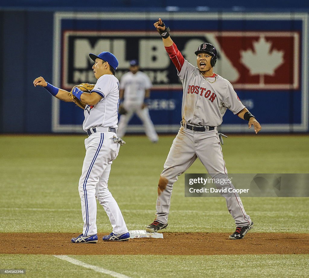 Mookie Betts (50) of the Boston Red Sox is called out at 2nd on a steal attempt as Munenori Kawasaki (66) of the Toronto Blue Jays applies the tag in the top of the 7th. He was ruled safe on appeal.