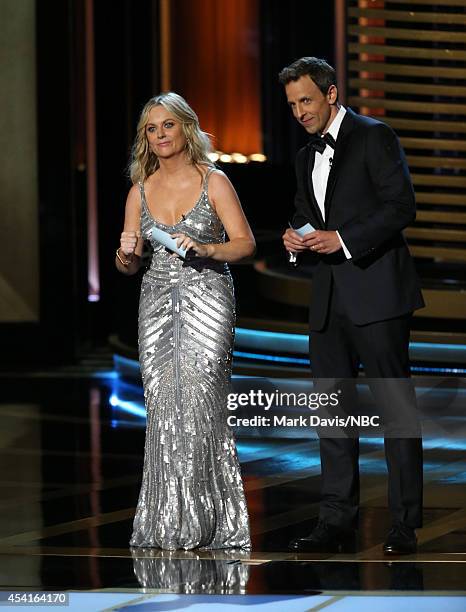 66th ANNUAL PRIMETIME EMMY AWARDS -- Pictured: Actress Amy Poehler and host Seth Meyers speak on stage during the 66th Annual Primetime Emmy Awards...