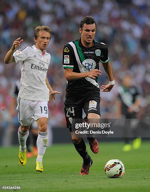 Mike Havenaar of Crodoba CF outpaces Luka Modric of Real Madrid during the La liga match between Real Madrid CF and Cordoba CF at Estadio Santiago...