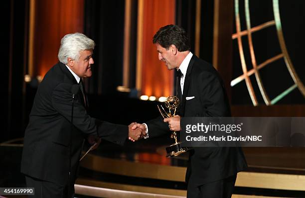 66th ANNUAL PRIMETIME EMMY AWARDS -- Pictured: Comedian Jay Leno presents the Outstanding Comedy Series award to writer/producer Steven Levitan on...
