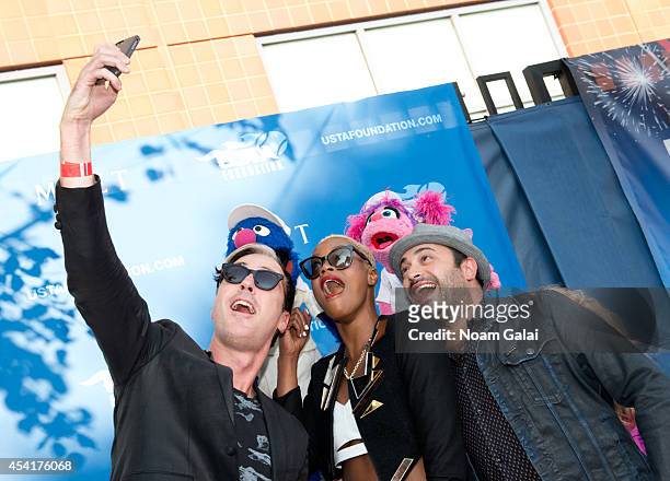 Fitz And The Tantrums band members Michael Fitzpatrick, Noelle Scaggs and James King take a selfie with Grover and Abby Cadabby at the 14th Annual...