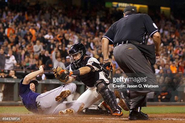 LeMahieu of the Colorado Rockies is tagged out by Andrew Susac of the San Francisco Giants at home plate in front of umpire Doug Eddings during the...