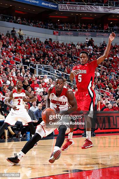 Chris Jones of the Louisville Cardinals drives to the basket against Kasey Shepherd of the Louisiana-Lafayette Ragin' Cajuns during the game at KFC...