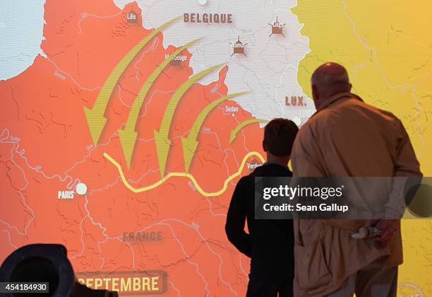 Visitors look at a video presentation showing the German advance against British and French armies in the Schlieffen Plan prior to the First Battle...