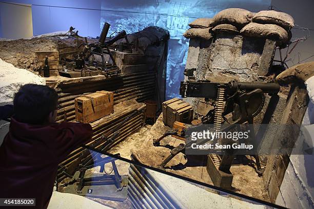 Young visitor looks at an exhibit of a German trench from World War I at the Museum of the Great War at Meaux on August 25, 2014 in Meaux, France. At...