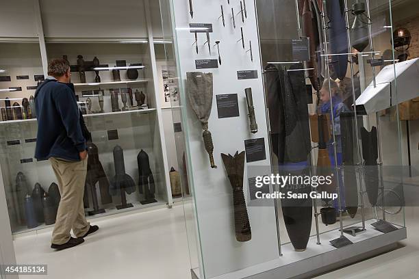 Visitor looks at an exhibit of artillery shells and bombs dropped from aircraft used by the Germans and the French during World War I at the Museum...