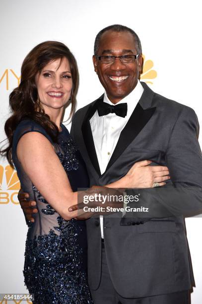 Christine Lietz and actor Joe Morton pose in the press room during the 66th Annual Primetime Emmy Awards held at Nokia Theatre L.A. Live on August...