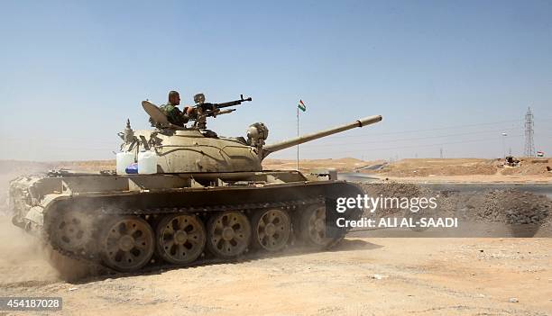 Peshmerga fighter stands guard in a tank at their post in the strategic Jalawla area, in Diyala province, which is a gateway to Baghdad, as battles...