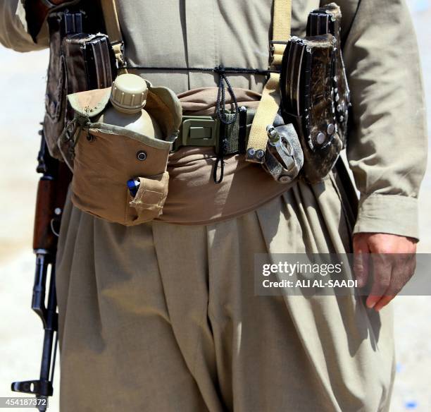 The belt of a Peshmerga fighter is seen as he stands guard at a post in the strategic Jalawla area, in Diyala province, which is a gateway to...