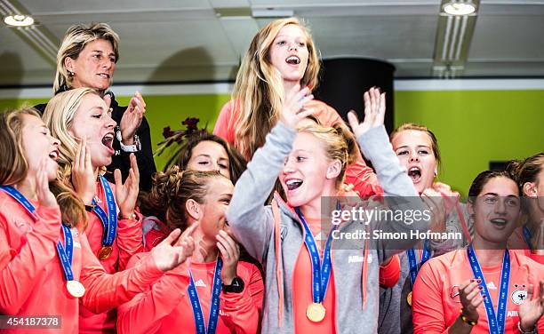 The team celebrates during the Germany U20 Women's Welcome Home Reception As World Champions at Frankfurt International Airport on August 26, 2014 in...