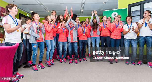 The team celebrates during the Germany U20 Women's Welcome Home Reception As World Champions at Frankfurt International Airport on August 26, 2014 in...