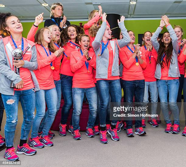 The team celebrates during the Germany U20 Women's Welcome Home Reception As World Champions at Frankfurt International Airport on August 26, 2014 in...