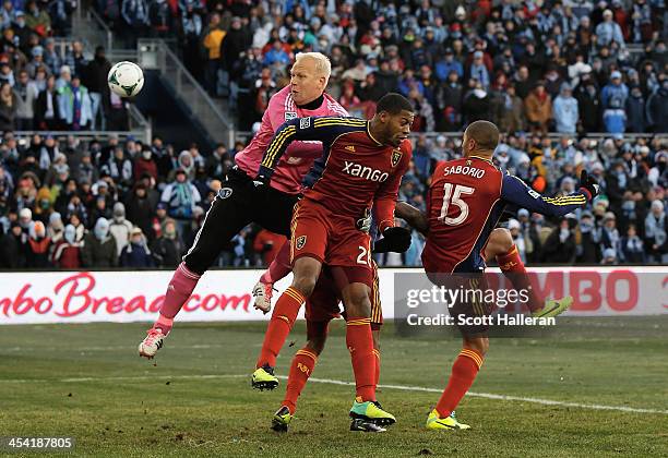 Jimmy Nielsen of Sporting KC makes a save against Chris Schuler and Alvaro Saboru of Real Salt Lake in the first half of the 2013 MLS Cup at Sporting...