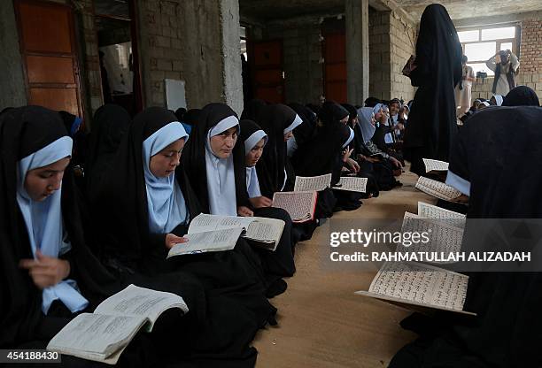 Afghan students read and memorise the holy Quran at a madrassa in Ghazni on August 26, 2014. Afghanistan's two presidential candidates, Abdullah...