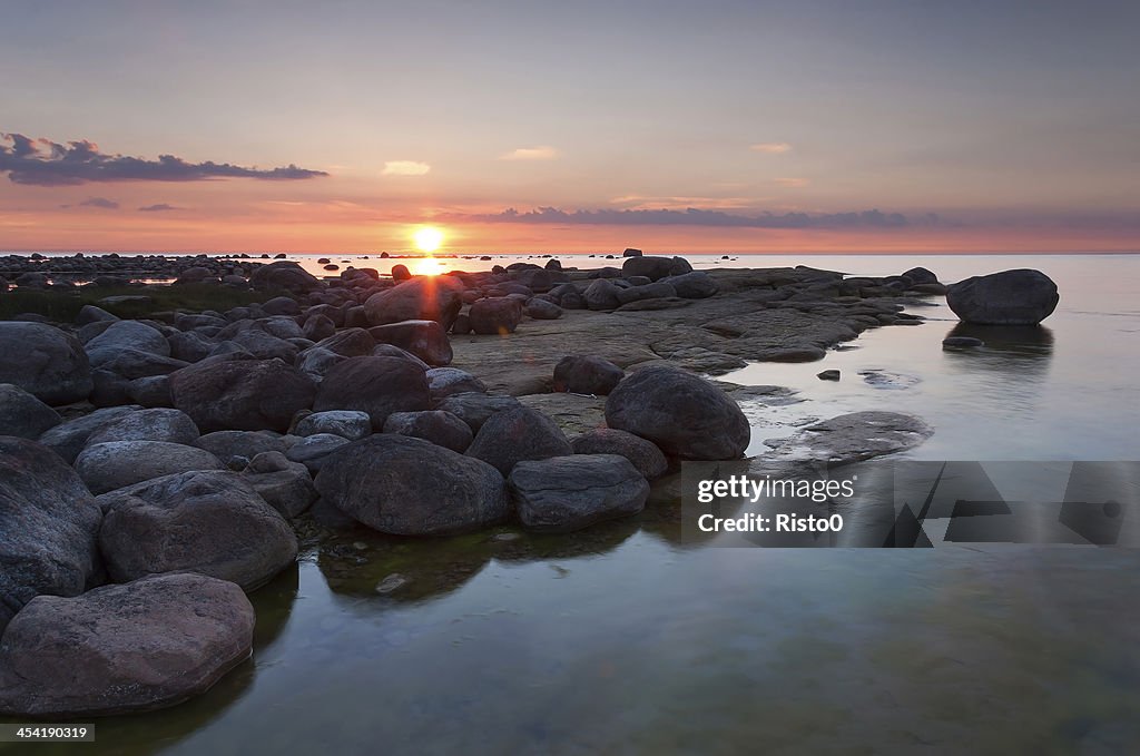 Puesta de sol detrás de rocky coast