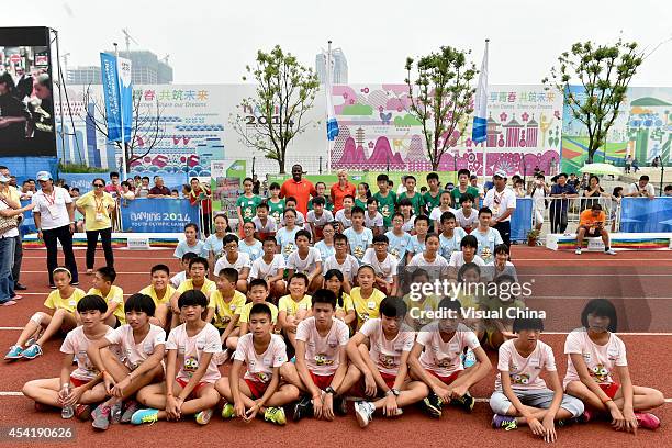 Former high jumper Kajsa Bergqvist of Sweden and World Long Jump champion Dwight Phillips of United States talks to children during the IAAF Kids...