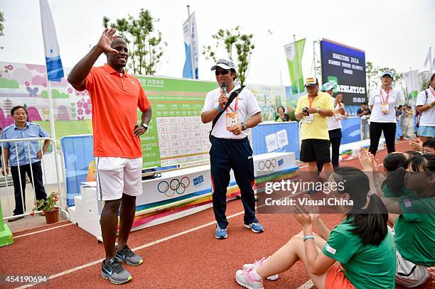 World Long Jump champion Dwight Phillips of United States talks to children during the IAAF Kids Athletics Program at Yanshan Road on August 26, 2014...