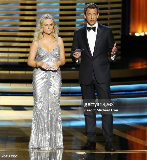 Amy Poehler and host Seth Meyers speak onstage during the 66th Annual Primetime Emmy Awards held at Nokia Theatre L.A. Live on August 25, 2014 in Los...