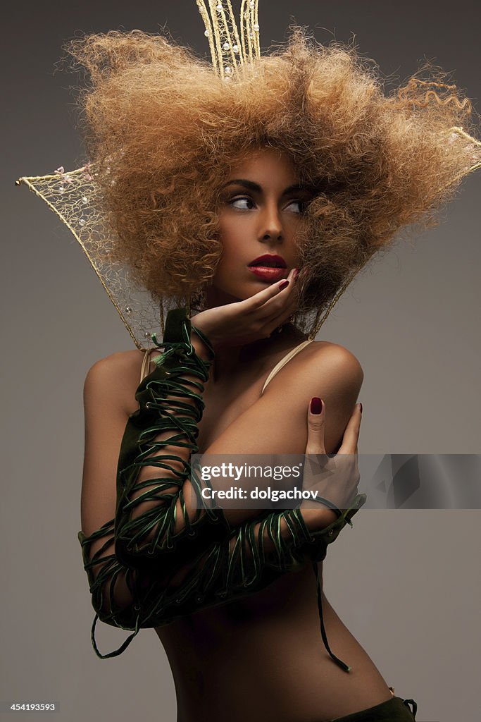 Woman with long curly hair in crown