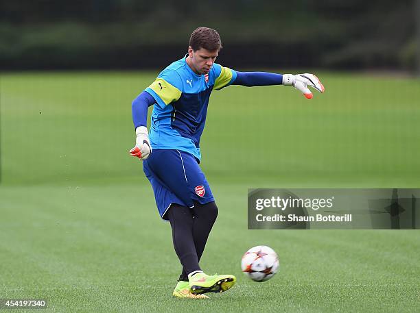 Wojciech Szczesny of Arsenal fires in a shot during a training session at London Colney on August 26, 2014 in St Albans, England.