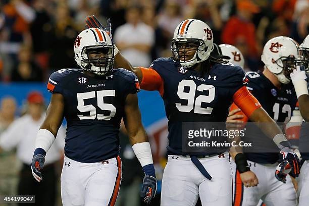 Carl Lawson of the Auburn Tigers celebrates a sack with teammate Kenneth Carter in the second quarter against the Missouri Tigers during the SEC...
