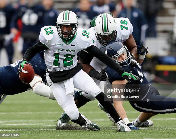 Rakeem Cato of the Marshall Thundering Herd scrambles out of the pocket as he gets a block from Garrett Scott against the Rice Owls at Rice Stadium...