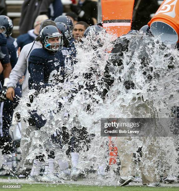 David Bailff, head coach of the Rice Owls , is doused in a wall of water as the Rice Owls defeated the Marshall Thundering Herd to win the Conference...