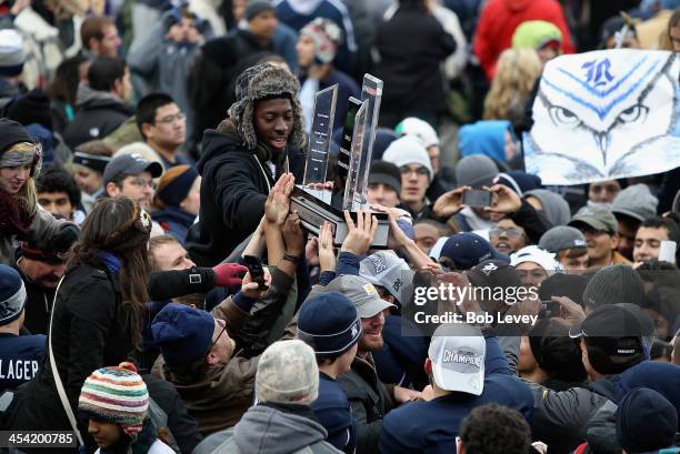 Members of the Rice University student body get their hands on the Conference USA trophy after defeating Marshall Thundering Herd at Rice Stadium on...