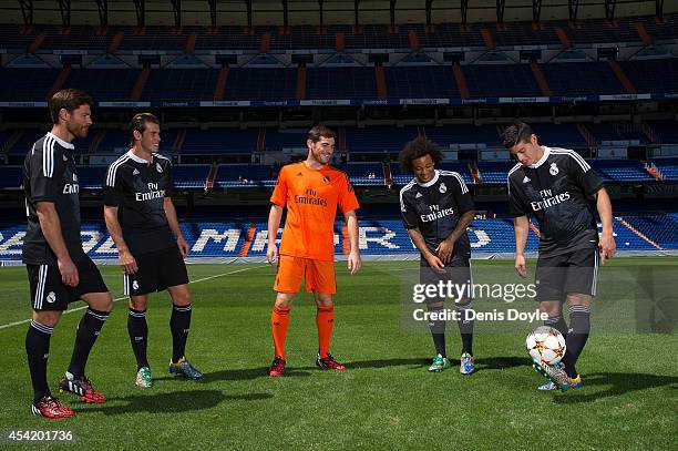 James Rodriguez of Real Madrid CF controls the ball while teammates Xabi Alonso Gareth Bale, Iker Casillas and Marcelo of Real Madrid during the...