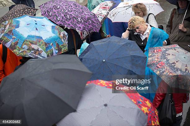 Sightseers visit Trafalgar Square in inclement weather on August 26, 2014 in London, England. Many areas of England, especially the South East,...