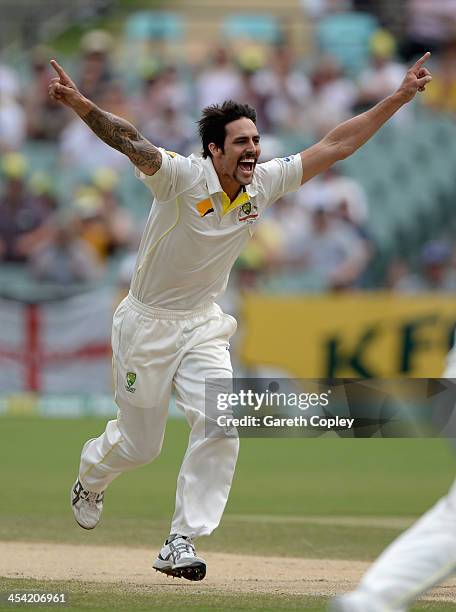 Mitchell Johnson of Australia celebrates dismissing England captain Alastair Cook during day four of the Second Ashes Test Match between Australia...