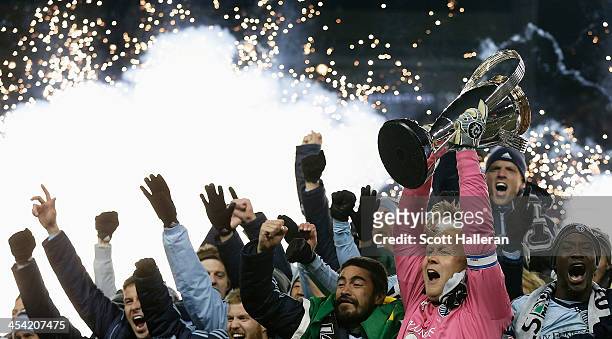 Jimmy Nielsen of Sporting KC celebrates with the Philip F. Anschutz trophy and his teammates after defeating Real Salt Lake in penalty kicks to win...